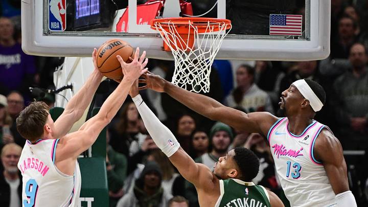 Jan 23, 2025; Milwaukee, Wisconsin, USA; Miami Heat guard Pelle Larsson (9) and center Bam Adebayo (13) reach for a rebound against Milwaukee Bucks forward Giannis Antetokounmpo (34) in the first quarter at Fiserv Forum. Mandatory Credit: Benny Sieu-Imagn Images Jan 23, 2025; Milwaukee, Wisconsin, USA; Miami Heat guard Pelle Larsson (9) and center Bam Adebayo (13) reach for a rebound against Milwaukee Bucks forward Giannis Antetokounmpo (34) in the first quarter at Fiserv Forum. Mandatory Credit: Benny Sieu-Imagn Images