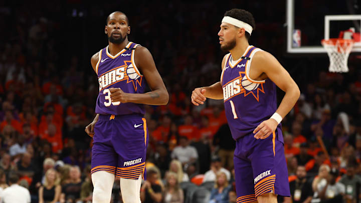 Oct 26, 2024; Phoenix, Arizona, USA; Phoenix Suns forward Kevin Durant (35) and guard Devin Booker (1) against the Dallas Mavericks in the home opener at Footprint Center. Mandatory Credit: Mark J. Rebilas-Imagn Images