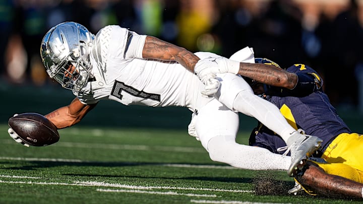 Oregon wide receiver Evan Stewart is tackled by Michigan defensive back Makari Paige during the first half at Michigan Stadium in Ann Arbor on Saturday, Nov. 2, 2024.