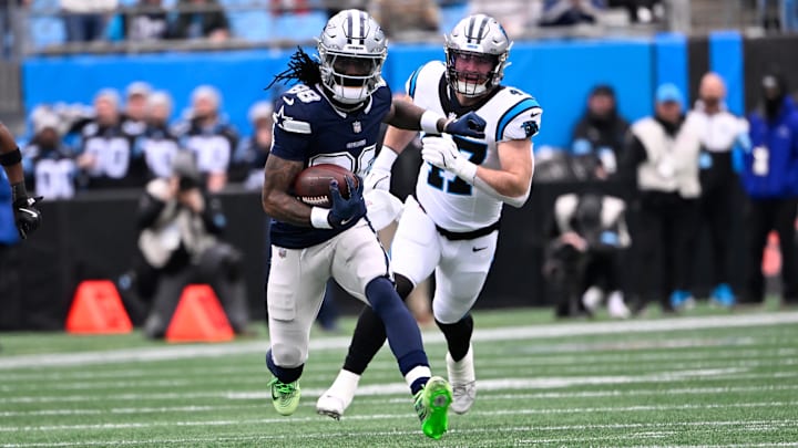 Dallas Cowboys wide receiver CeeDee Lamb with the ball as Carolina Panthers linebacker Josey Jewell defends.