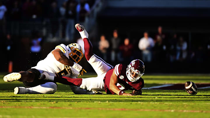 Nov 23, 2024; Starkville, Mississippi, USA; Mississippi State Bulldogs quarterback Michael Van Buren Jr. (0) fumbles as he is sacked by Missouri Tigers defensive tackle Kristian Williams (5) during the first quarter at Davis Wade Stadium at Scott Field. Mandatory Credit: Matt Bush-Imagn Images