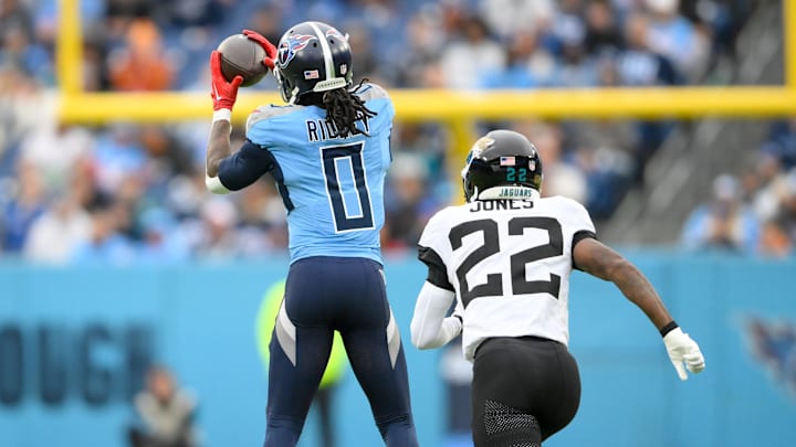 Dec 8, 2024; Nashville, Tennessee, USA;  Tennessee Titans wide receiver Calvin Ridley (0) makes a catch in front of Jacksonville Jaguars cornerback Jarrian Jones (22) during the first half at Nissan Stadium. Mandatory Credit: Steve Roberts-Imagn Images