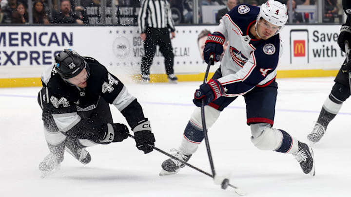 Nov 9, 2024; Los Angeles, California, USA; Columbus Blue Jackets center Cole Sillinger (4) shoots against Los Angeles Kings defenseman Mikey Anderson (44) during the third period at Crypto.com Arena. Mandatory Credit: Jason Parkhurst-Imagn Images