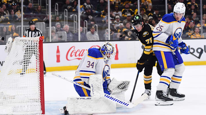 Apr 26, 2026; Boston, Massachusetts, USA; Buffalo Sabres goaltender Alex Lyon (34) makes a save in front of Boston Bruins forward Lukas Reichel (75) during the third period in game four of the first round of the 2026 Stanley Cup Playoffs at TD Garden. Mandatory Credit: Bob DeChiara-Imagn Images