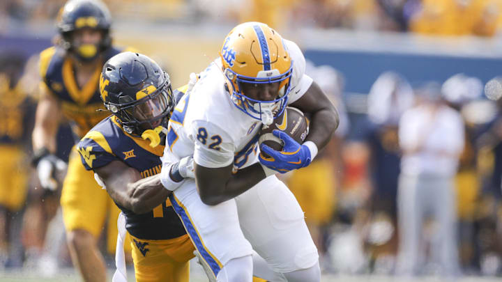 Sep 13, 2025; Morgantown, West Virginia, USA; Pittsburgh Panthers tight end Malachi Thomas (82) makes a catch and runs for extra yards during the first quarter against the West Virginia Mountaineers at Milan Puskar Stadium. Mandatory Credit: Ben Queen-Imagn Images