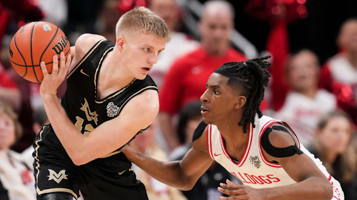 Crown Point Bulldogs guard Bryce Peters (11) guards Mt. Vernon Marauders guard Luke Ertel (12).