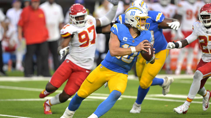 Los Angeles Chargers QB Justin Herbert is pressured by Kansas City Chiefs defensive end Felix Anudike-Uzomah.