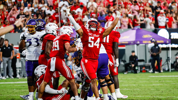 Aug 28, 2025; Raleigh, North Carolina, USA; North Carolina State Wolfpack defensive end Sabastian Harsh (54) celebrates a sack during the first half of the game against East Carolina Pirates at Carter-Finley Stadium. Mandatory Credit: Jaylynn Nash-Imagn Images Aug 28, 2025; Raleigh, North Carolina, USA; North Carolina State Wolfpack defensive end Sabastian Harsh (54) celebrates a sack during the first half of the game against East Carolina Pirates at Carter-Finley Stadium. Mandatory Credit: Jaylynn Nash-Imagn Images