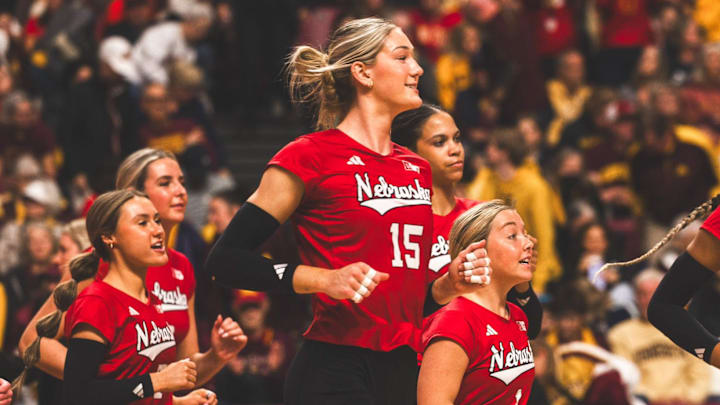 Andi Jackson runs onto the court to celebrate with her teammates after Nebraska finished off a sweep against Minnesota. Jackson led the Huskers with 15 kills.
