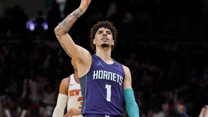 Mar 20, 2025; Charlotte, North Carolina, USA; Charlotte Hornets guard LaMelo Ball (1) signals for his three point shot against the New York Knicks during the second half at Spectrum Center. Mandatory Credit: Jim Dedmon-Imagn Images