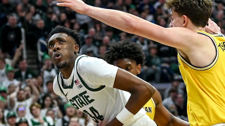 Michigan State's Xavier Booker looks for room under the basket against Michigan during the first half