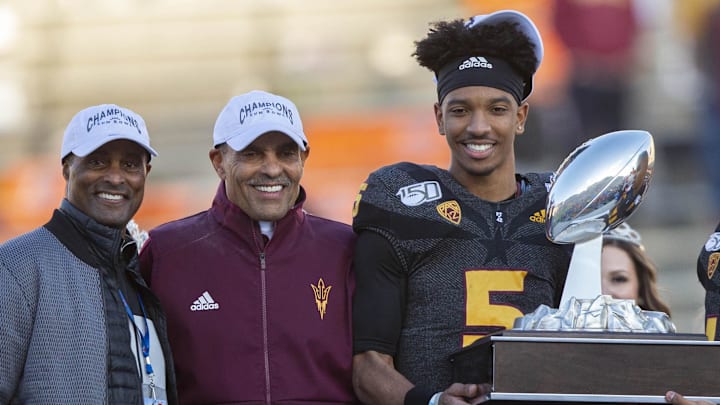 Dec 31, 2019; El Paso, Texas, USA; L-R Arizona State AD Ray Anderson, head coach Herm Edwards, quarterback Jayden Daniels (5), place kicker Cristian Zendejas (45), Brant Wheaton, Marketing Director of Kellogg U.S. Ready-To-Eat Cereal segment pose for photos after the Sun Devils defeated the Florida State Seminoles 20-14 in the Sun Bowl. Mandatory Credit: Leonel Ramirez-Imagn Images