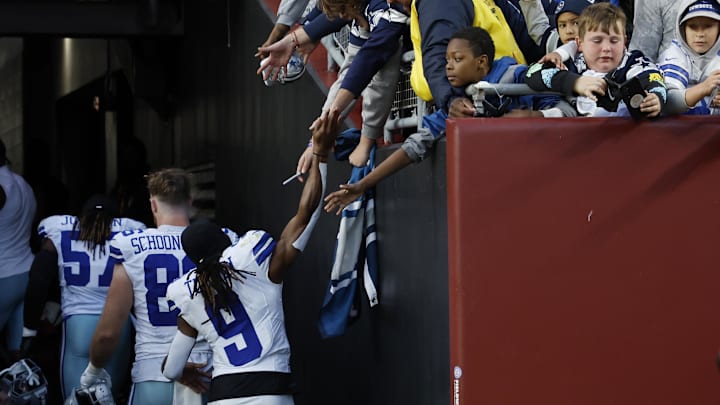 Dallas Cowboys wide receiver KaVontae Turpin shakes hands with fans while leaving the field after the Cowboys' game.