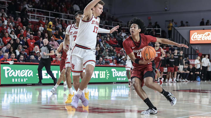 Nov 30, 2024; Queens, New York, USA; Harvard Crimson guard Robert Hinton (4) looks to drive past St. John's Red Storm forward Ruben Prey (17) in the first half at Carnesecca Arena. Nov 30, 2024; Queens, New York, USA; Harvard Crimson guard Robert Hinton (4) looks to drive past St. John's Red Storm forward Ruben Prey (17) in the first half at Carnesecca Arena.