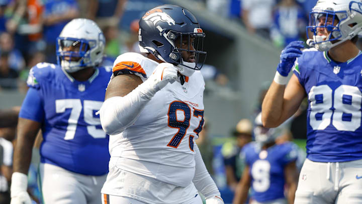 Sep 8, 2024; Seattle, Washington, USA; Denver Broncos defensive tackle D.J. Jones (93) celebrates a holding penalty against Seattle Seahawks guard Anthony Bradford (75) for a safety during the second quarter at Lumen Field.