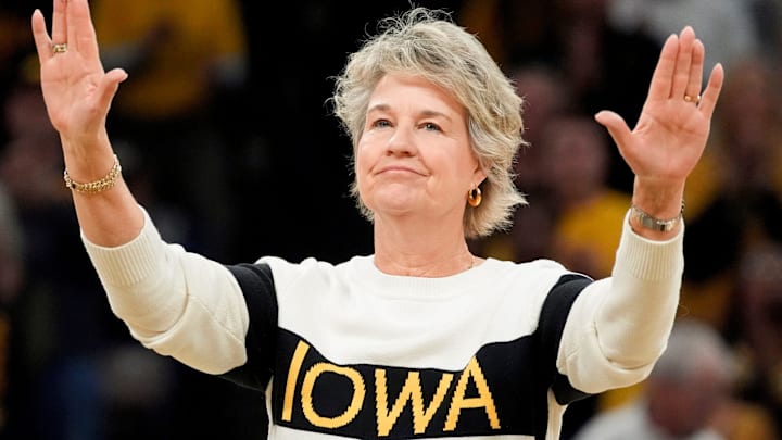 Former Iowa women’s basketball head coach Lisa Bluder, waves to the crowd during a recognition ceremony at halftime of the Iowa Hawkeyes game against the Maryland Terrapins Sunday, Jan. 5, 2025 at Carver-Hawkeye Arena in Iowa City, Iowa.