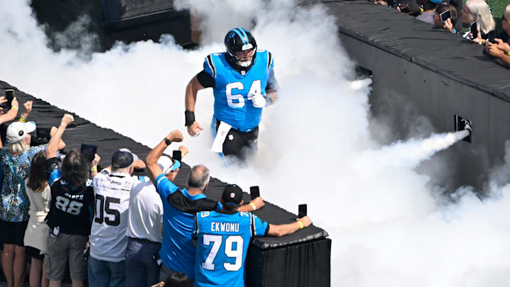 Carolina Panthers center Cade Mays (64) runs on to the field before the game at Bank of America Stadium