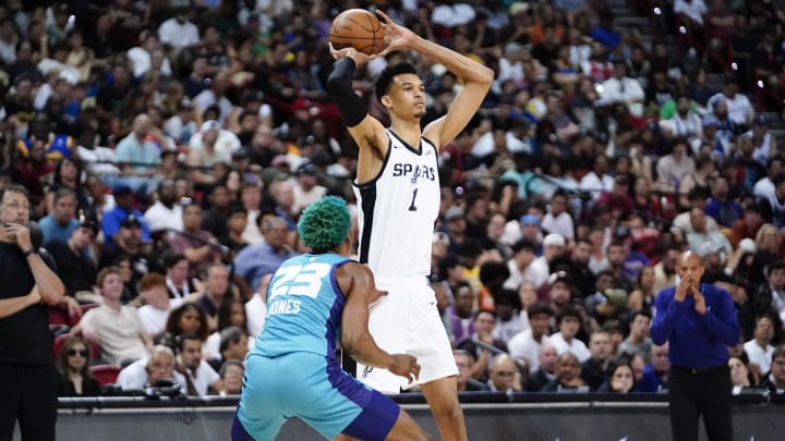 Jul 7, 2023; Las Vegas, NV, USA; San Antonio Spurs forward Victor Wembanyama (1) controls the ball against Charlotte Hornets forward/center Kai Jones (23) during the second half at Thomas & Mack Center. Mandatory Credit: Lucas Peltier-USA TODAY Sports