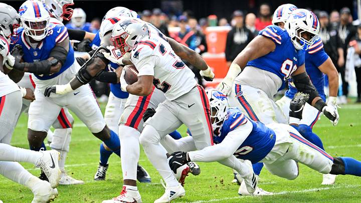 Oct. 4, 2026; Orchard Park, New York, USA; New England Patriots' running back Treveyon Henderson (32) rushes as Buffalo Bills' EDGE defender Greg Rousseau (15) attempts to make a tackle during the third quarter at Highmark Stadium in Week 4. Oct. 4, 2026; Orchard Park, New York, USA; New England Patriots' running back Treveyon Henderson (32) rushes as Buffalo Bills' EDGE defender Greg Rousseau (15) attempts to make a tackle during the third quarter at Highmark Stadium in Week 4.