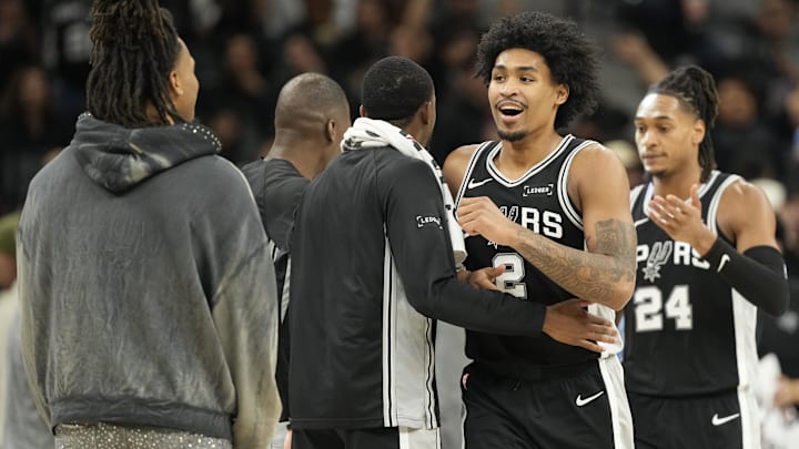 Dec 2, 2025; San Antonio, Texas, USA; San Antonio Spurs guard Dylan Harper (2) is congratulated by teammates after scoring before a timeout in the second half against the Memphis Grizzlies at Frost Bank Center. Mandatory Credit: Scott Wachter-Imagn Images Dec 2, 2025; San Antonio, Texas, USA; San Antonio Spurs guard Dylan Harper (2) is congratulated by teammates after scoring before a timeout in the second half against the Memphis Grizzlies at Frost Bank Center. Mandatory Credit: Scott Wachter-Imagn Images