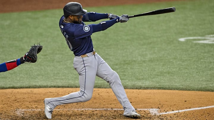 Seattle Mariners right fielder Victor Robles hits a single against the Texas Rangers on Sept. 22 at Globe Life Field.