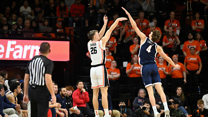 Feb 7, 2026; Corvallis, Oregon, USA; Oregon State Beavers guard Matija Samar (26) scores on a three-point shot over Gonzaga Bulldogs guard Davis Fogle (4) during the first half at Gill Coliseum. Mandatory Credit: Craig Strobeck-Imagn Images