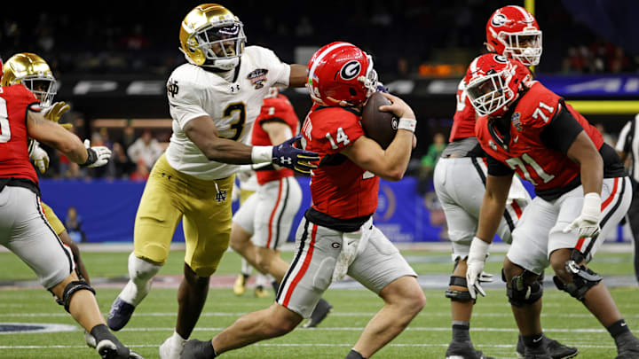 Jan 2, 2025; New Orleans, LA, USA; Georgia Bulldogs quarterback Gunner Stockton (14) runs with the ball during the second half against Notre Dame Fighting Irish running back Gi'Bran Payne (3) at Caesars Superdome. Mandatory Credit: Amber Searls-Imagn Images