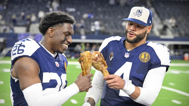 Dallas Cowboys cornerback DaRon Bland and Dak Prescott eat turkey legs after a win over the Washington Commanders 