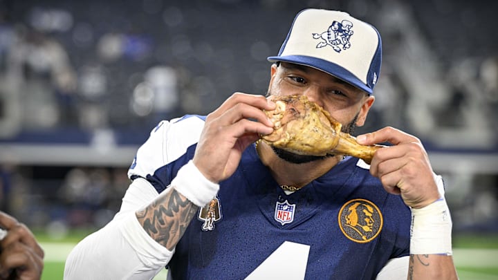 Dallas Cowboys Dak Prescott eats a turkey leg after the Cowboys victory over the Washington Commanders at AT&T Stadium.