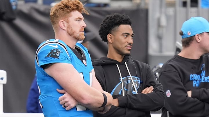 Oct 26, 2025; Charlotte, North Carolina, USA; Carolina Panthers quarterback Andy Dalton (14) and quarterback Bryce Young (9) on the sideline during the second half against the Buffalo Bills at Bank of America Stadium. Oct 26, 2025; Charlotte, North Carolina, USA; Carolina Panthers quarterback Andy Dalton (14) and quarterback Bryce Young (9) on the sideline during the second half against the Buffalo Bills at Bank of America Stadium.