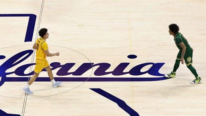 Cal point guard Justin Pippen, right, brings the ball up court