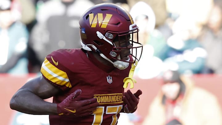 Dec 22, 2024; Landover, Maryland, USA; Washington Commanders wide receiver Terry McLaurin (17) celebrates after catching a touchdown pass against the Philadelphia Eagles during the second quarter at Northwest Stadium. Mandatory Credit: Geoff Burke-Imagn Images
