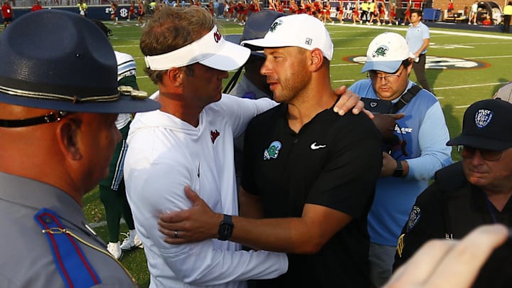 Sep 20, 2025; Oxford, Mississippi, USA; Mississippi Rebels head coach Lane Kiffin (left) and Tulane Green Wave head coach Jon Sumrall (right) embrace after the game at Vaught-Hemingway Stadium. Mandatory Credit: Petre Thomas-Imagn Images Sep 20, 2025; Oxford, Mississippi, USA; Mississippi Rebels head coach Lane Kiffin (left) and Tulane Green Wave head coach Jon Sumrall (right) embrace after the game at Vaught-Hemingway Stadium. Mandatory Credit: Petre Thomas-Imagn Images
