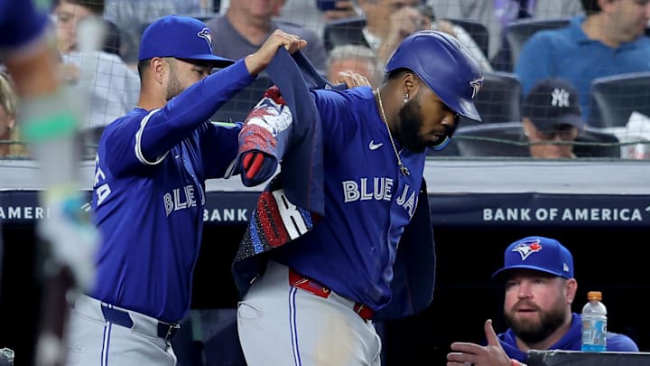 Toronto Blue Jays shortstop Isiah Kiner-Falefa (7) puts the home run jacket on first baseman Vladimir Guerrero Jr. (27) after Guerrero hit a solo home run the New York Yankees during the fifth inning at Yankee Stadium.