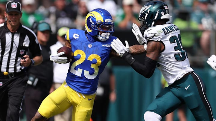 Sep 21, 2025; Philadelphia, Pennsylvania, USA; Los Angeles Rams running back Kyren Williams (23) rushes the ball past Philadelphia Eagles linebacker Jihaad Campbell (30) during the first half at Lincoln Financial Field. Mandatory Credit: Bill Streicher-Imagn Images