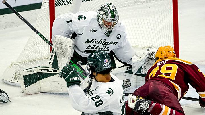 Michigan State's Trey Augustine, left, blocks the goal from Minnesota's Mason Moe during the first period on Friday, Jan. 23, 2026, at Munn Ice Arena in East Lansing.