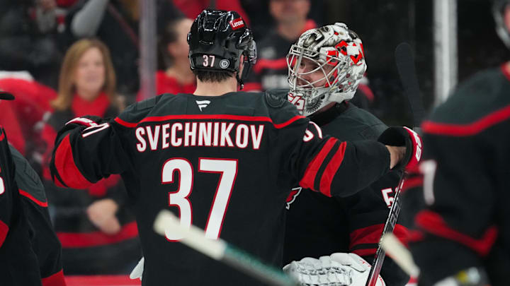 Dec 17, 2024; Raleigh, North Carolina, USA;  Carolina Hurricanes right wing Andrei Svechnikov (37) and goaltender Pyotr Kochetkov (52) celebrate their victory against the New York Islanders at Lenovo Center. Mandatory Credit: James Guillory-Imagn Images