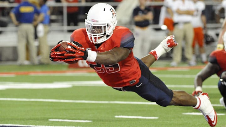 Sep 14, 2013; Tucson, AZ, USA; Arizona Wildcats running back KaDeem Carey (25) scores a touchdown that was later called back because of an illegal formation during the fourth quarter against the Texas-San Antonio Roadrunners at Arizona Stadium. The Wildcats defeated the Roadrunners 38-13. Mandatory Credit: Casey Sapio-Imagn Images Sep 14, 2013; Tucson, AZ, USA; Arizona Wildcats running back KaDeem Carey (25) scores a touchdown that was later called back because of an illegal formation during the fourth quarter against the Texas-San Antonio Roadrunners at Arizona Stadium. The Wildcats defeated the Roadrunners 38-13. Mandatory Credit: Casey Sapio-Imagn Images
