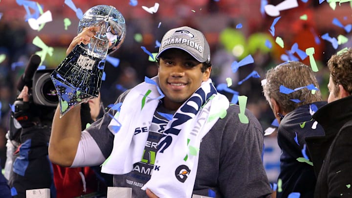 Feb 2, 2014; East Rutherford, NJ, USA; Seattle Seahawks quarterback Russell Wilson (3) celebrates with the Lombardi Trophy after beating the Denver Broncos 43-8 in Super Bowl XLVIII at MetLife Stadium.