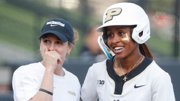 Purdue Boilermakers head coach Magali Frezzotti talks to outfielder Khloe Banks (2).