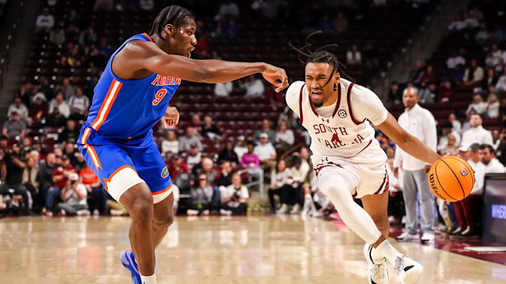 Jan 28, 2026; Columbia, South Carolina, USA; South Carolina Gamecocks guard Kobe Knox (4) attempts to drives around Florida Gators center Rueben Chinyelu (9) in the first half at Colonial Life Arena. Mandatory Credit: Jeff Blake-Imagn Images Jan 28, 2026; Columbia, South Carolina, USA; South Carolina Gamecocks guard Kobe Knox (4) attempts to drives around Florida Gators center Rueben Chinyelu (9) in the first half at Colonial Life Arena. Mandatory Credit: Jeff Blake-Imagn Images