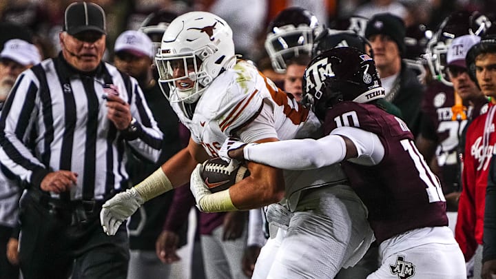 Nov 30, 2024; College Station, Texas, USA; Texas Longhorns tight end Gunnar Helm (85) is tackled by Texas A&M defensive back Dezz Ricks (10) during the Lone Star Showdown at Kyle Field. Mandatory Credit: Sara Diggins/USA TODAY Network via Imagn Images