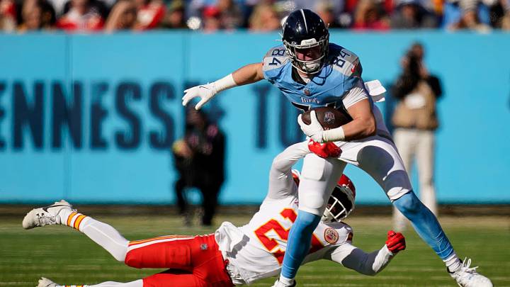 Tennessee Titans tight end Gunnar Helm (84) tries to slip past Kansas City Chiefs safety Chamarri Conner (27) during the second quarter at Nissan Stadium in Nashville, Tenn., Sunday, Dec. 21, 2025.
