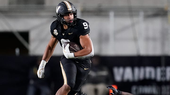 Vanderbilt tight end Eli Stowers (9) evades Ball State defensive back George Udo (10) during the fourth quarter at FirstBank Stadium in Nashville, Tenn., Saturday, Oct. 19, 2024. Vanderbilt tight end Eli Stowers (9) evades Ball State defensive back George Udo (10) during the fourth quarter at FirstBank Stadium in Nashville, Tenn., Saturday, Oct. 19, 2024.