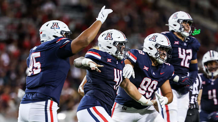 Aug 30, 2025; Tucson, Arizona, USA; Arizona Wildcats defensive lineman Leroy Palu (95), defensive lineman Julian Savaiinaea (41), defensive lineman Mays Pese (99), and defensive lineman Dominic Lolesio (42) all celebrate after they intercept the ball from the Hawaii Rainbow Warriors during the third quarter at Arizona Stadium. Mandatory Credit: Aryanna Frank-Imagn Images Aug 30, 2025; Tucson, Arizona, USA; Arizona Wildcats defensive lineman Leroy Palu (95), defensive lineman Julian Savaiinaea (41), defensive lineman Mays Pese (99), and defensive lineman Dominic Lolesio (42) all celebrate after they intercept the ball from the Hawaii Rainbow Warriors during the third quarter at Arizona Stadium. Mandatory Credit: Aryanna Frank-Imagn Images