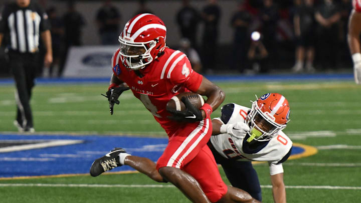 Mater Dei’s Kayden Dixon-Wyatt catches a pass and eludes a Bishop Gorman defender on Friday, September 6, 2024. Mater Dei’s Kayden Dixon-Wyatt catches a pass and eludes a Bishop Gorman defender on Friday, September 6, 2024.