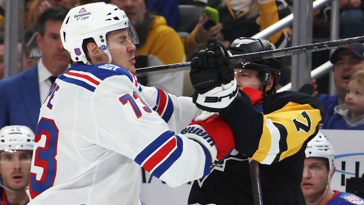 Jan 31, 2026; Pittsburgh, Pennsylvania, USA;  New York Rangers center Matt Rempe (73) gets checked in the face by Pittsburgh Penguins defenseman Ilya Solovyov (7) during the third period at PPG Paints Arena. Mandatory Credit: Charles LeClaire-Imagn Images