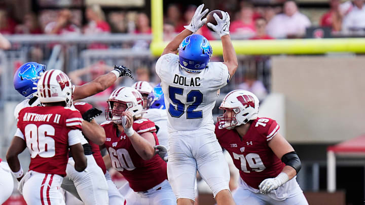Buffalo linebacker Shaun Dolac (52) intercepts the ball in the fourth quarter of game against Wisconsin.