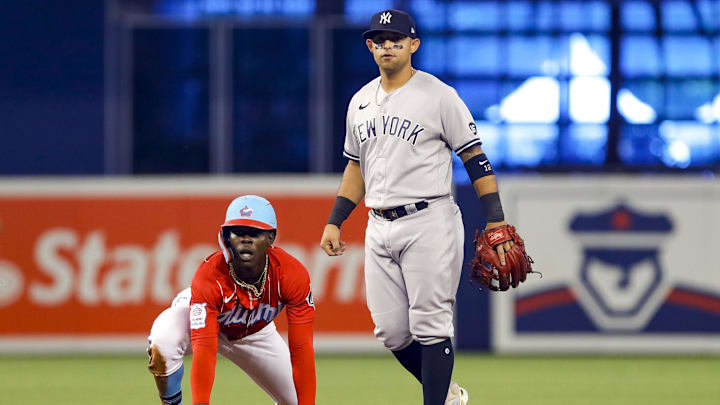 Aug 1, 2021; Miami, Florida, USA; Miami Marlins second baseman Jazz Chisholm Jr. (2) reacts after sliding into second base as New York Yankees second baseman Rougned Odor (12) watches his throw to first base during the first inning at loanDepot Park. Mandatory Credit: Sam Navarro-USA TODAY Sports