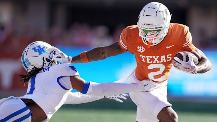 Texas Longhorns wide receiver Matthew Golden (2) stiff arms Kentucky Wildcats defensive back Maxwell Hairston (1) in the first quarter of an NCAA college football game at Darrell K Royal Texas Memorial Stadium in Austin, Texas on Saturday, Nov. 24, 2024.